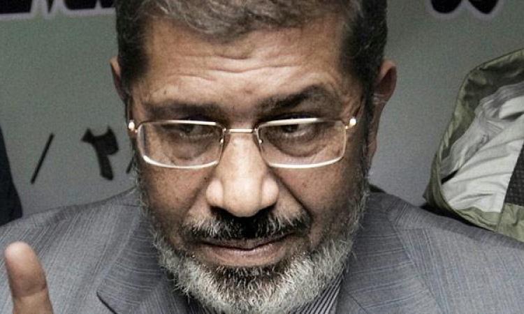 مرسي من داخل القفص: كلفت “العوا” بالدفع بعدم دستورية المحكمة وبطلانها