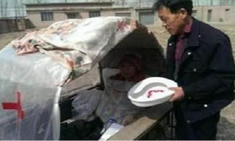 رجل صينى يقوم بعمل سيارة لزوجته لينقلها بها إلى المستشفى