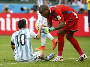 Nigeria's goalkeeper Vincent Enyeama helps Argentina's Lionel Messi up during their 2014 World Cup Group F soccer match at the Beira Rio stadium in Porto Alegre